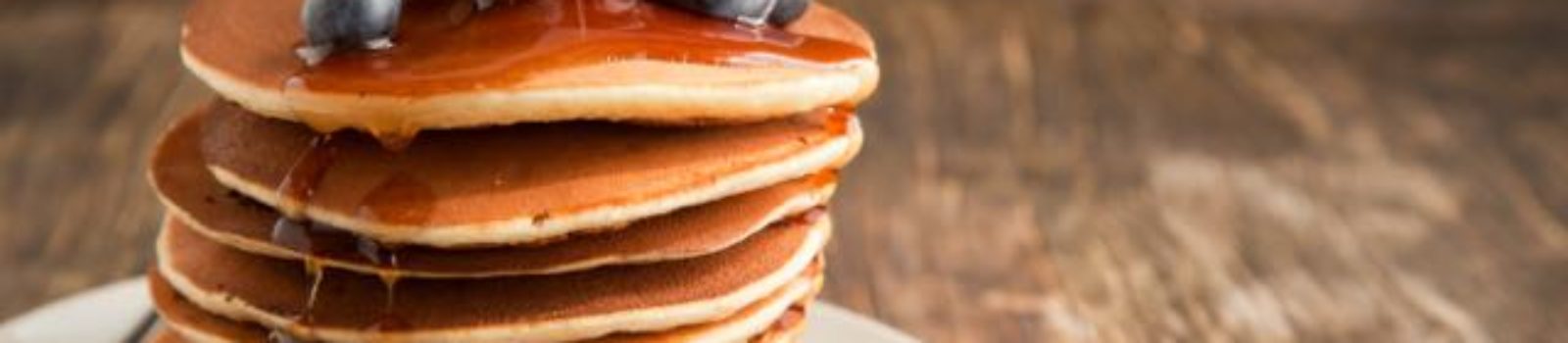 Berry pancakes stack with maple syrup