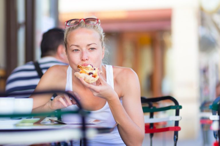 lady snacking on pizza (1)
